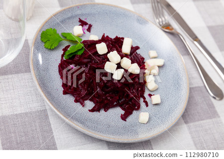 Salad with chopped beetroot and farmer cheese decorated with parsley 112980710