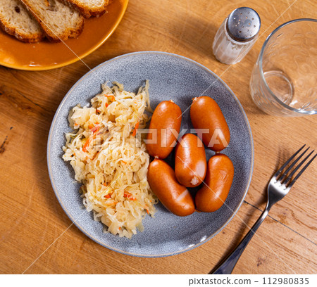 Tasty sausages with side dish of sauerkraut 112980835