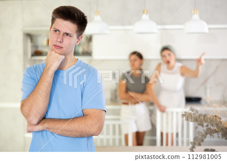 Woman mother and young girl during family quarrel accuse adult son 112981005