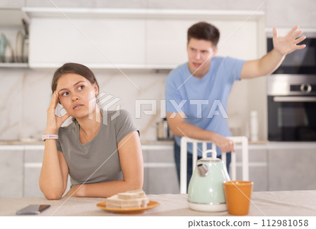 Young couple is quarreling while in kitchen, girl is silent Young couple is quarreling while in kitchen, girl is silent 112981058