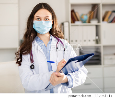 Woman doctor wear white medical uniform and stethoscope in mask 112981214