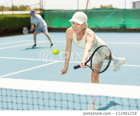 Senior woman plays tennis 112981258