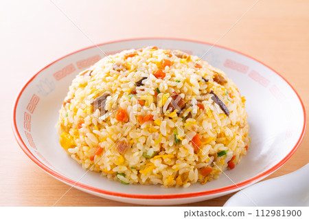 Eating fried rice at a Chinese restaurant 112981900