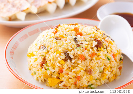 Eating fried rice and fried dumplings at a Chinese restaurant Eating fried rice and fried dumplings at a Chinese restaurant 112981958