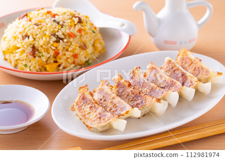 Eating fried dumplings and fried rice at a Chinese restaurant 112981974