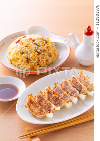 Eating fried dumplings and fried rice at a Chinese restaurant 112981976