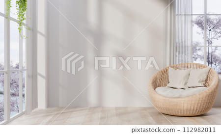 The interior design of a contemporary minimalist living room with a round wicker lounge armchair. 112982011