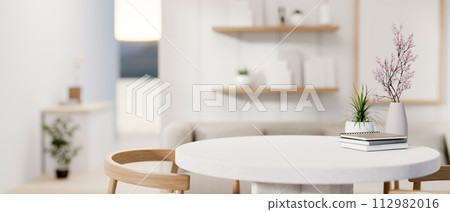 A space for displaying products on a white round table in a cozy contemporary living room. A space for displaying products on a white round table in a cozy contemporary living room. 112982016