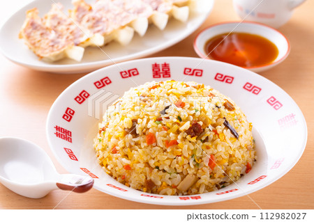 Eating fried rice and fried dumplings at a Chinese restaurant Eating fried rice and fried dumplings at a Chinese restaurant 112982027