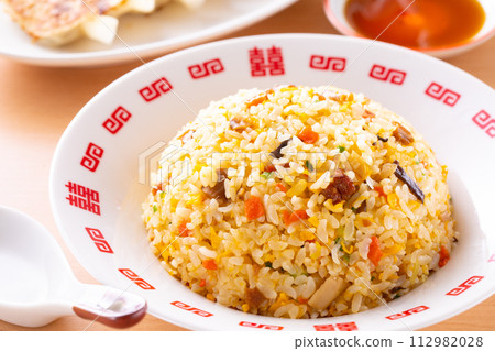 Eating fried rice and fried dumplings at a Chinese restaurant Eating fried rice and fried dumplings at a Chinese restaurant 112982028