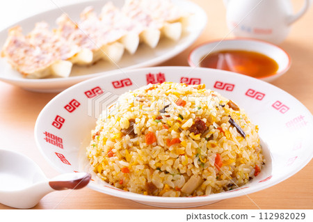 Eating fried rice and fried dumplings at a Chinese restaurant Eating fried rice and fried dumplings at a Chinese restaurant 112982029