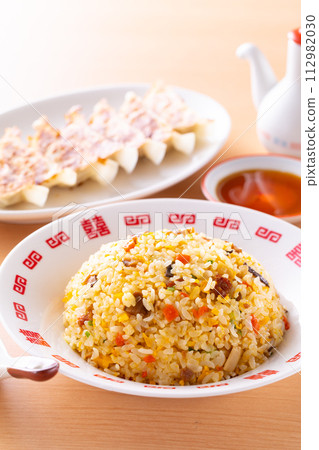 Eating fried rice and fried dumplings at a Chinese restaurant 112982030