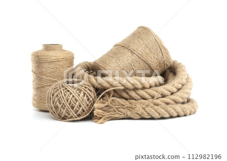 Rolls of natural jute rope and twine isolated on white Rolls of natural jute rope and twine isolated on white 112982196