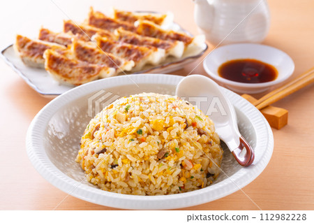 Eating fried rice and fried dumplings at a Chinese restaurant Eating fried rice and fried dumplings at a Chinese restaurant 112982228