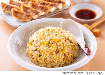 Eating fried rice and fried dumplings at a Chinese restaurant Eating fried rice and fried dumplings at a Chinese restaurant 112982264