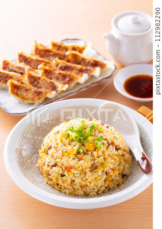 Eating fried rice and fried dumplings at a Chinese restaurant 112982290