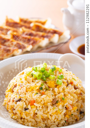 Eating fried rice and fried dumplings at a Chinese restaurant 112982291