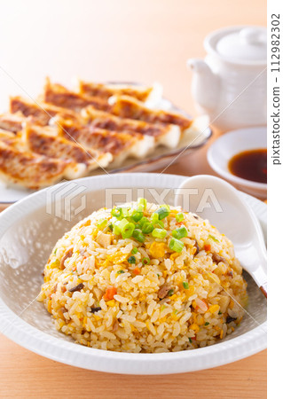 Eating fried rice and fried dumplings at a Chinese restaurant Eating fried rice and fried dumplings at a Chinese restaurant 112982302