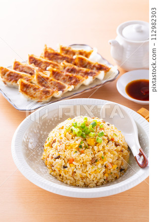 Eating fried rice and fried dumplings at a Chinese restaurant Eating fried rice and fried dumplings at a Chinese restaurant 112982303