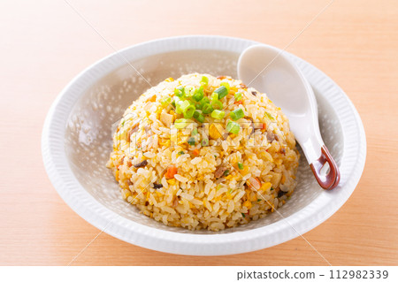 Eating fried rice at a Chinese restaurant Eating fried rice at a Chinese restaurant 112982339