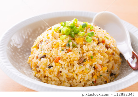 Eating fried rice at a Chinese restaurant Eating fried rice at a Chinese restaurant 112982345