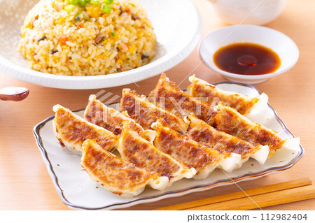 Eating fried dumplings and fried rice at a Chinese restaurant Eating fried dumplings and fried rice at a Chinese restaurant 112982404