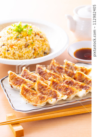 Eating fried dumplings and fried rice at a Chinese restaurant Eating fried dumplings and fried rice at a Chinese restaurant 112982405