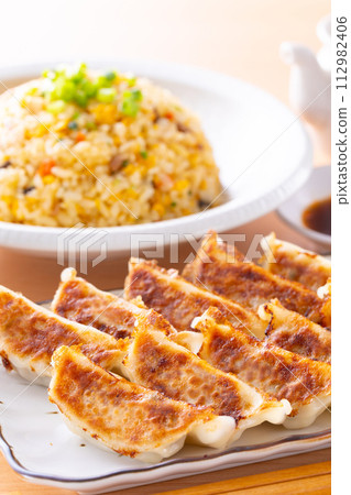 Eating fried dumplings and fried rice at a Chinese restaurant Eating fried dumplings and fried rice at a Chinese restaurant 112982406