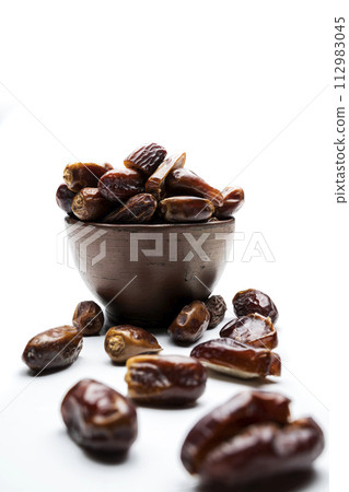 Dried dates fruit for iftar on Ramadan in the bowl Dried dates fruit for iftar on Ramadan in the bowl 112983045