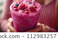 berry cocktail in female hands close-up 112983257
