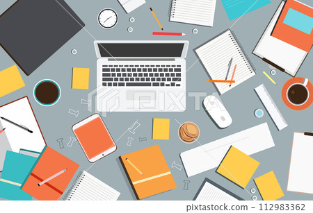 Messy Work Desk with Computer Book Pen Scattered on the Table 112983362