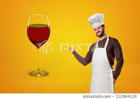 Chef presenting a giant wine glass 112984118