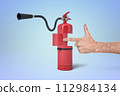 Red fire extinguisher shaped like a gun 112984134