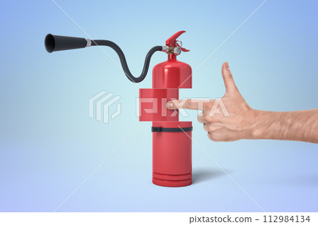 Red fire extinguisher shaped like a gun 112984134