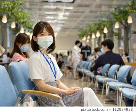 A woman wearing a mask at a hospital during the coronavirus pandemic A woman wearing a mask at a hospital during the coronavirus pandemic 112984958