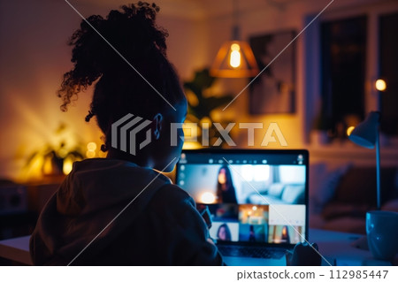 AI-generated content. Woman working late on laptop in dark room 112985447