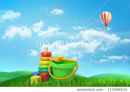 Toys and hot air balloon in a grass field Toys and hot air balloon in a grass field 112986014