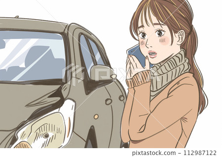 A woman who is in trouble because her car breaks down or has an accident calls by smartphone 112987122