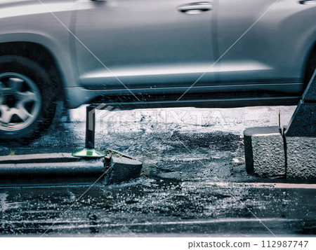 Water splash from a running car Water splash from a running car 112987747