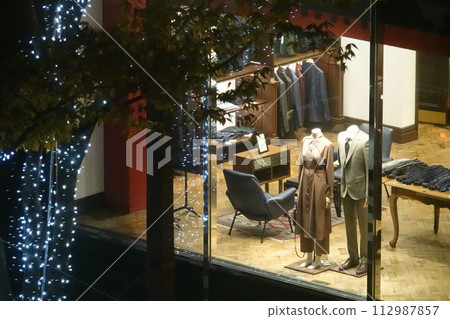 Illuminated street trees and boutique show windows Illuminated street trees and boutique show windows 112987857