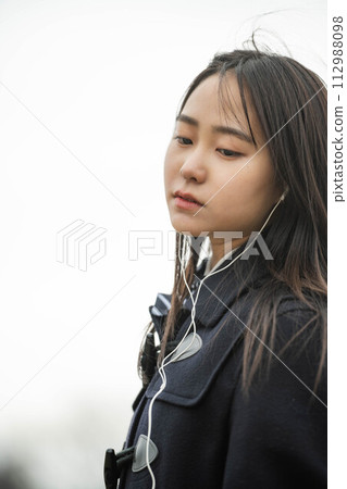 High school girl wearing earphones High school girl wearing earphones 112988098