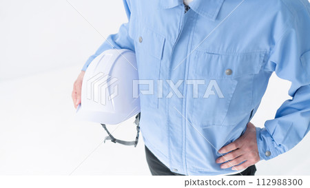 Man in work clothes, overhead view, no face 112988300
