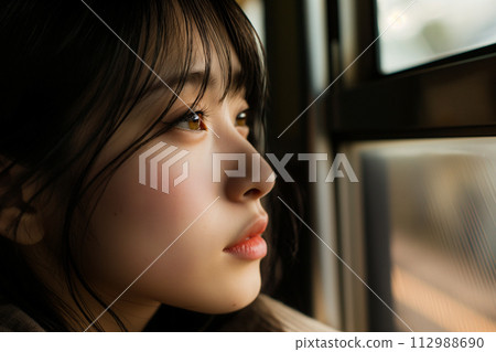A woman lost in thought on the train 112988690