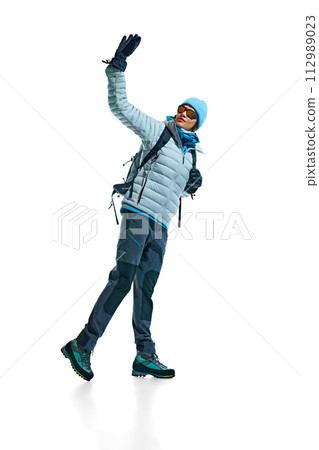 Young woman, climber wearing jacket, hat, goggles, backpack and durable footwear for hiking activity isolated on white background 112989023
