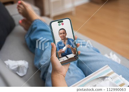 Patient engaging with doctor over telehealth on smartphone, discussing medication. Patient engaging with doctor over telehealth on smartphone, discussing medication. 112990063