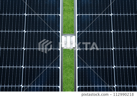 Solar panel on a background of green grass Solar panel on a background of green grass 112990218
