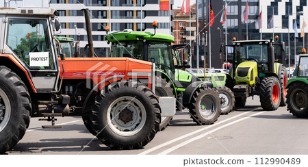 Farmers blocked traffic with tractors during a protest 112990489