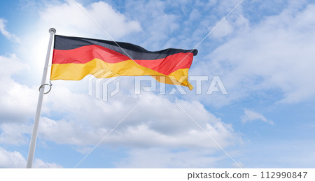 German flag flutters in the wind. State symbol of Federal Republic of Germany 112990847
