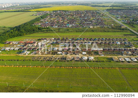 Construction of a suburban neighborhood of cottages. Aerial view. Construction of a suburban neighborhood of cottages. Aerial view. 112990894