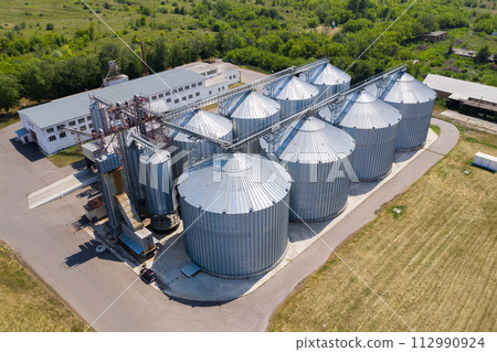 Aerial view of agricultural silos, grain elevator for storage and drying of cereals. 112990924